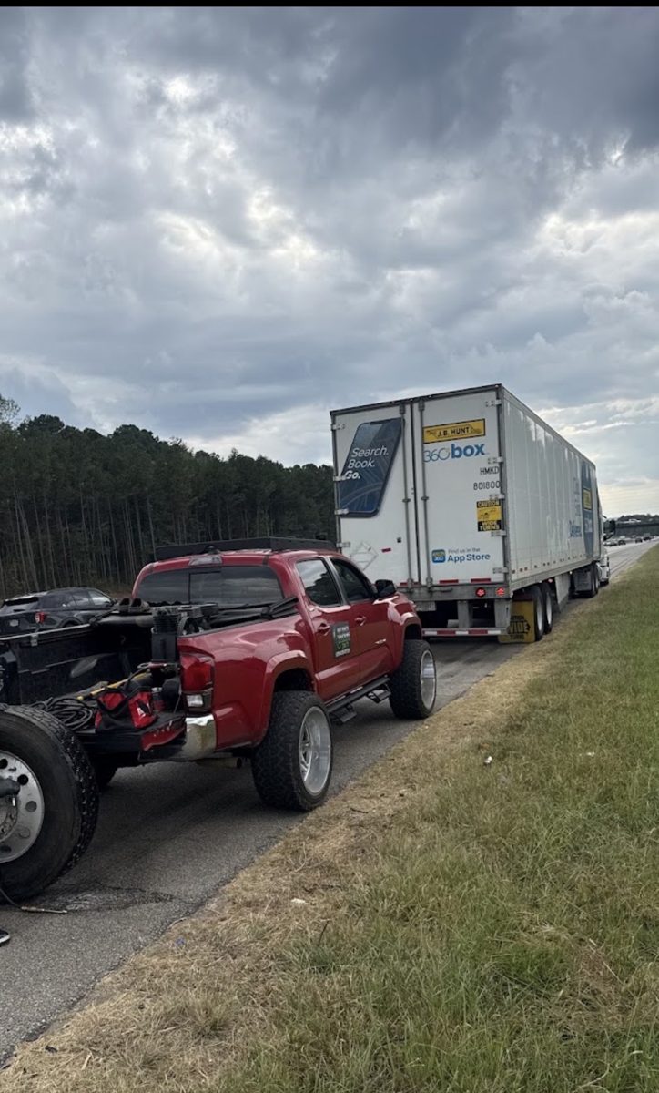 GBT service truck behind a box trailer on the highway